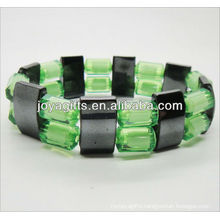 Magnetic spacer bracelet with green plastic beads